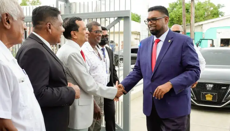 President Dr. Irfaan Ali interacts with Demerara Bank's Chief Executive Officer Pravichandra Dave and other stakeholders ahead of the launch of the new farmers' credit line programme (Photo: Office of the President/ May 30, 2022)