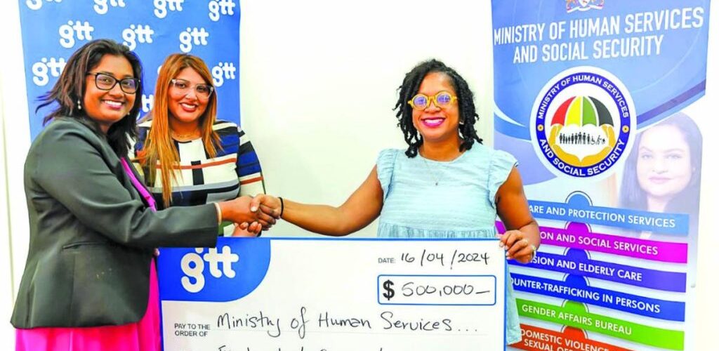 Demerara Bank and GTT reps hand over the monetary support to Human Services and Social Security Minister